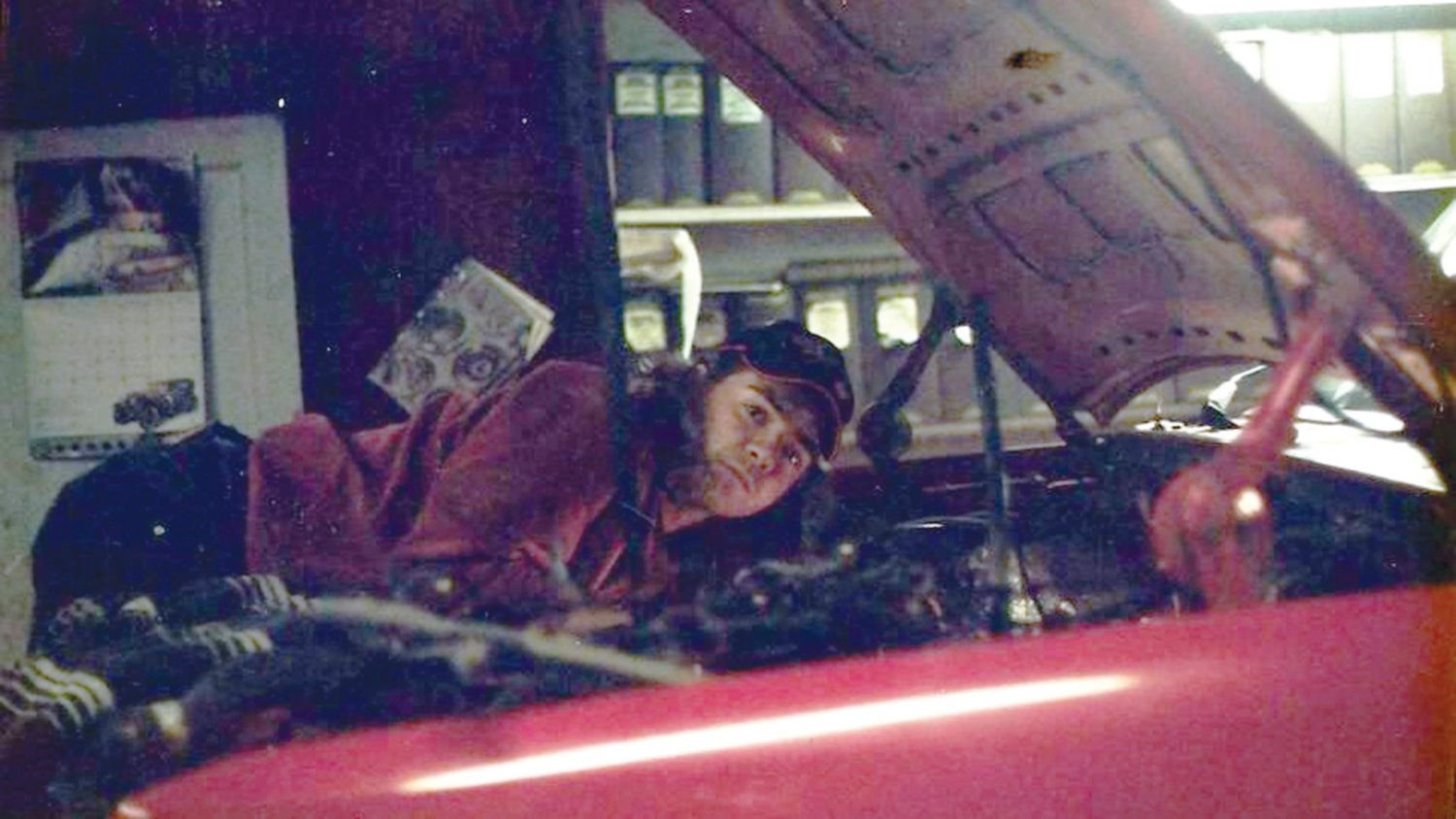 LIKE FATHER: Jay Carrera works on a car in his father’s garage in 2002. Although he won’t be taking the business over, Jay spent countless hours working side-by-side with his father.